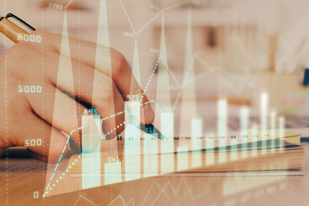 Double exposure of man doing notes of stock market with forex graph. Concept of research and trading.